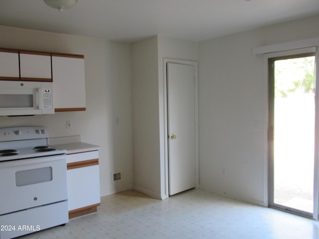 kitchen with white cabinets and white appliances