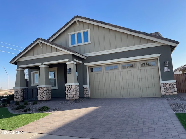 craftsman inspired home featuring a porch and a garage