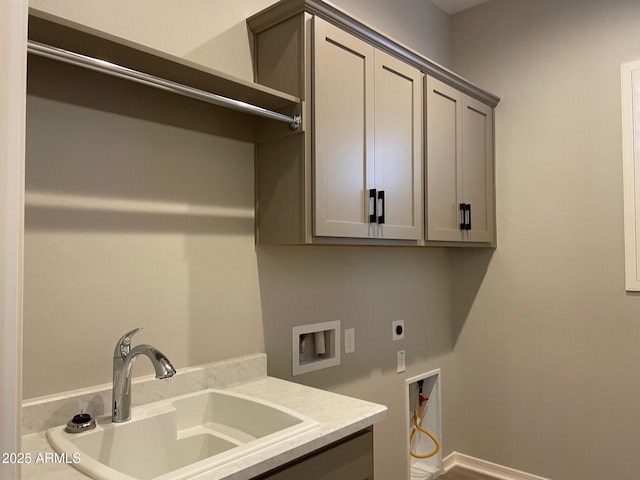 clothes washing area with sink, hookup for a washing machine, cabinets, and hookup for an electric dryer