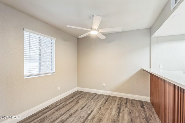 empty room featuring ceiling fan and hardwood / wood-style floors