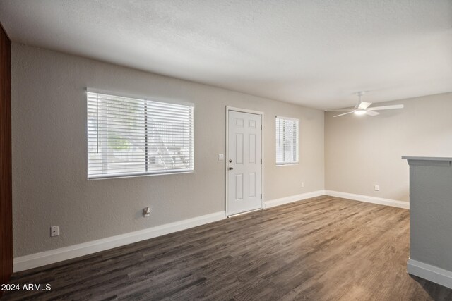 interior space with dark hardwood / wood-style floors and ceiling fan