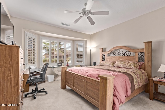 bedroom with light carpet, visible vents, and a ceiling fan