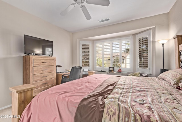 bedroom with visible vents, carpet flooring, baseboards, and a ceiling fan