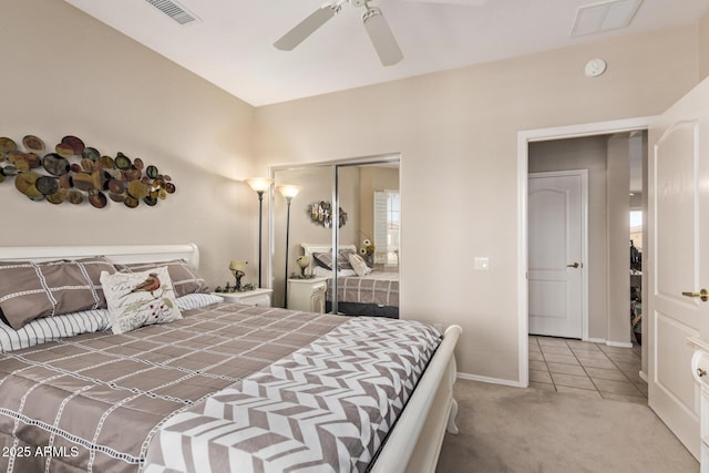 tiled bedroom with carpet flooring, visible vents, a closet, and baseboards