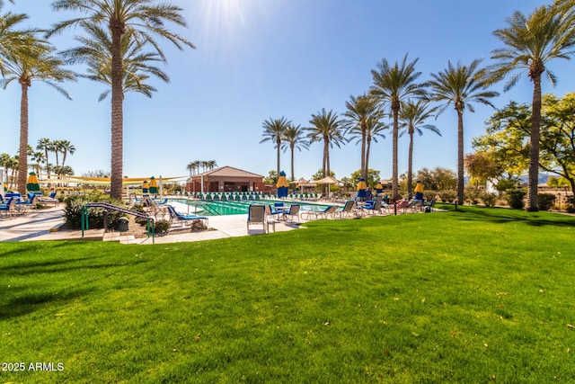 pool with a lawn and a patio