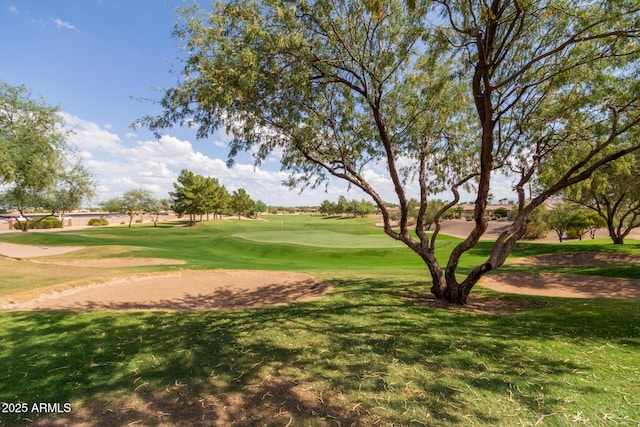 surrounding community with a lawn and view of golf course