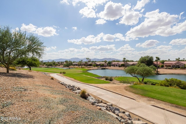 surrounding community featuring a yard and a water and mountain view