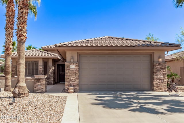 view of front facade featuring driveway, stucco siding, a garage, stone siding, and a tiled roof