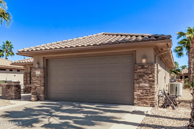 view of front facade featuring concrete driveway, a tiled roof, stone siding, and stucco siding