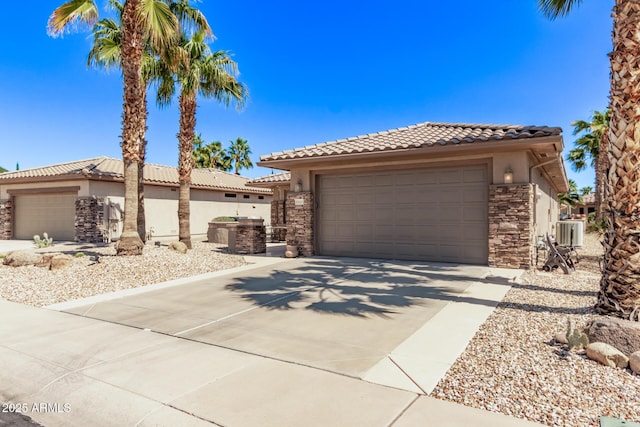 mediterranean / spanish-style home with stone siding, stucco siding, and a tiled roof