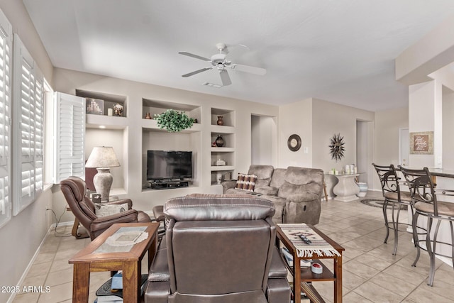 living room featuring built in shelves, visible vents, baseboards, light tile patterned flooring, and ceiling fan