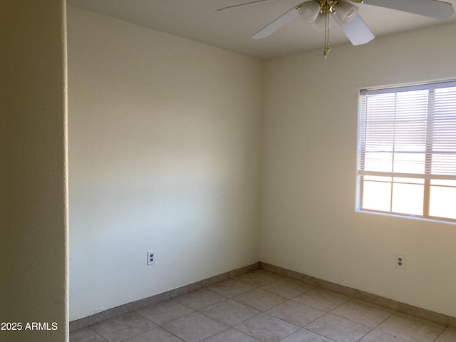 tiled empty room featuring ceiling fan