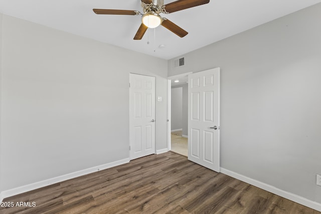 unfurnished bedroom with dark hardwood / wood-style floors and ceiling fan