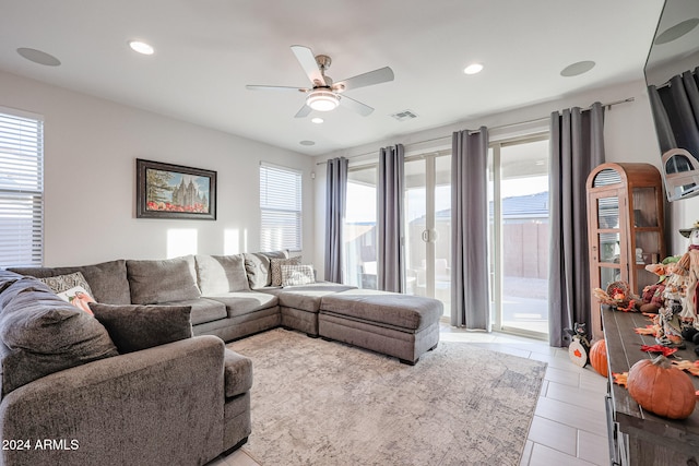 living room with a wealth of natural light and ceiling fan