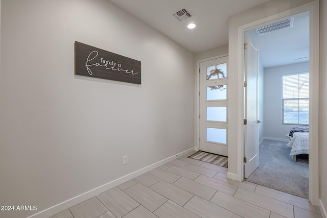 entryway featuring light carpet