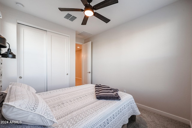 carpeted bedroom featuring ceiling fan and a closet