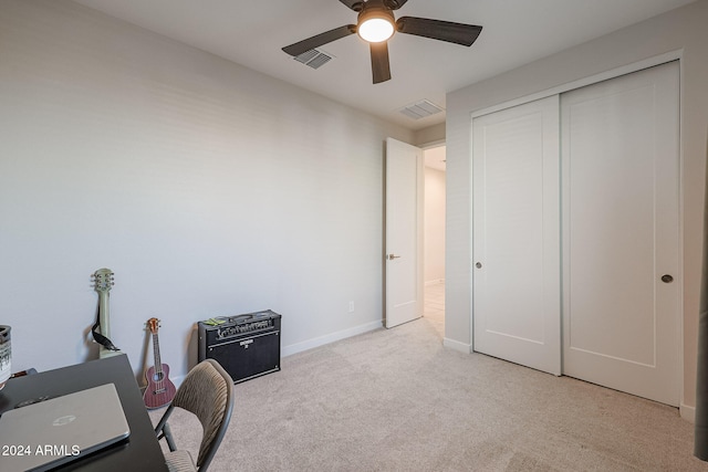 unfurnished office featuring ceiling fan and light colored carpet