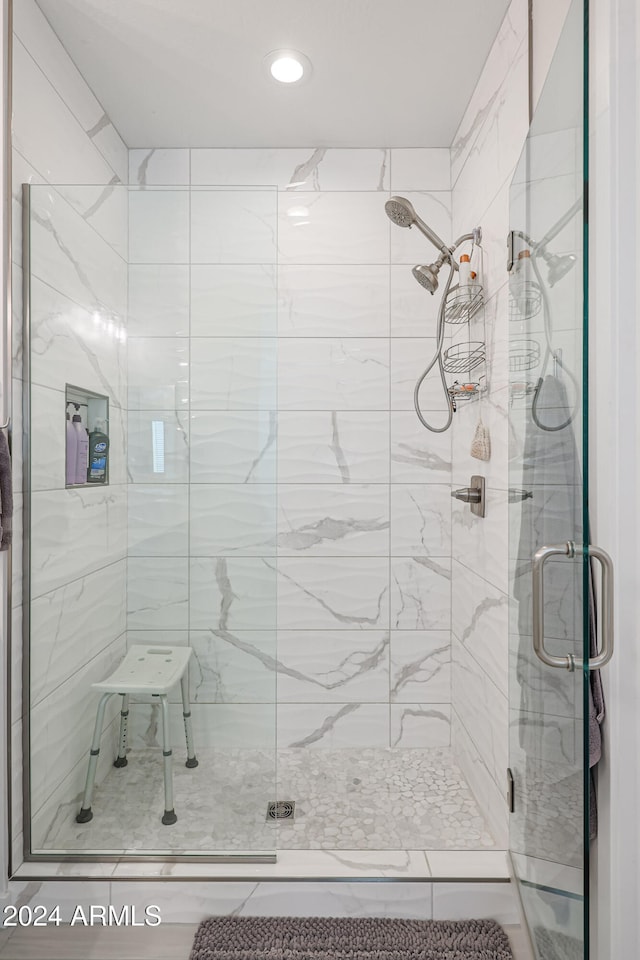 bathroom with a shower with shower door