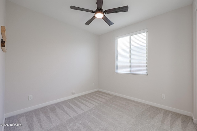 empty room with light colored carpet and ceiling fan