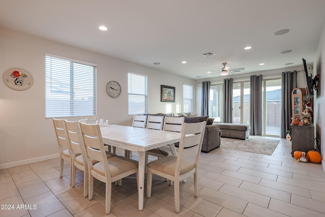 tiled dining area featuring plenty of natural light and ceiling fan