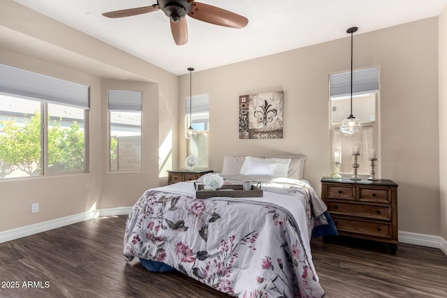 bedroom featuring a ceiling fan, baseboards, and dark wood-style flooring