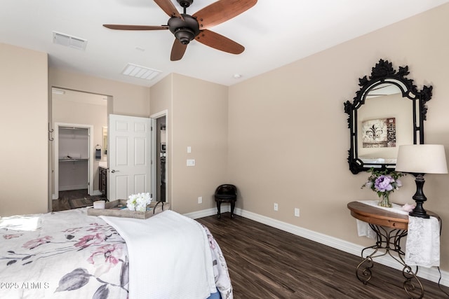 bedroom featuring baseboards, visible vents, ceiling fan, dark wood-type flooring, and a walk in closet