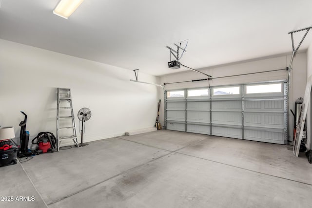 garage with a garage door opener and baseboards