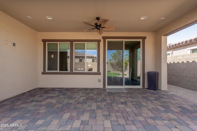 view of patio featuring a ceiling fan and fence