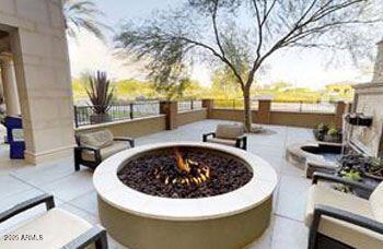 view of patio featuring fence and an outdoor fire pit