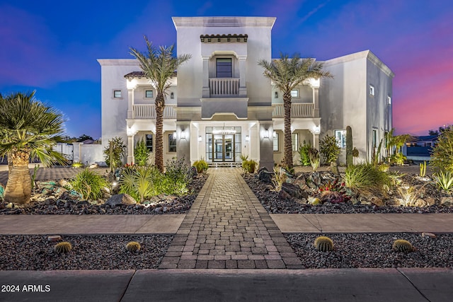 mediterranean / spanish-style house featuring french doors and a balcony