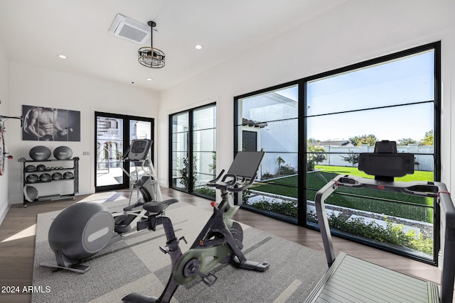 workout area with light hardwood / wood-style flooring