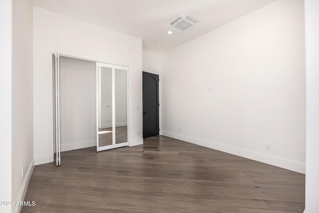 unfurnished bedroom featuring dark wood-type flooring