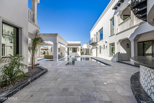 view of swimming pool with a patio