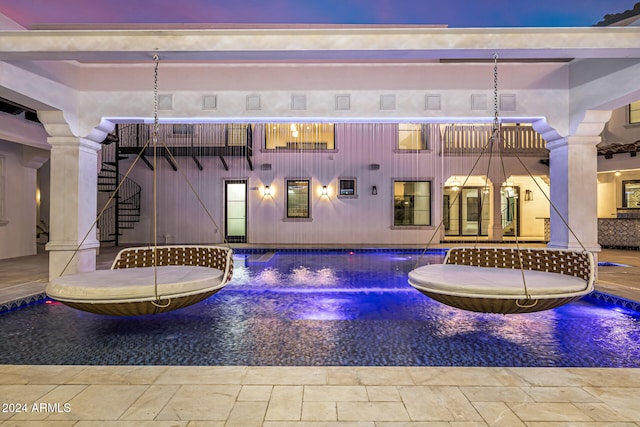 pool at dusk with pool water feature