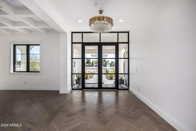 interior space with beamed ceiling, dark parquet floors, coffered ceiling, french doors, and a chandelier