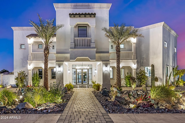 mediterranean / spanish-style home featuring a balcony and french doors