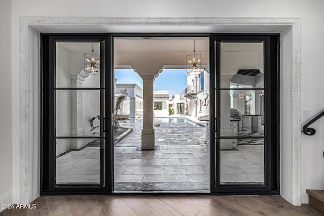 doorway with hardwood / wood-style floors