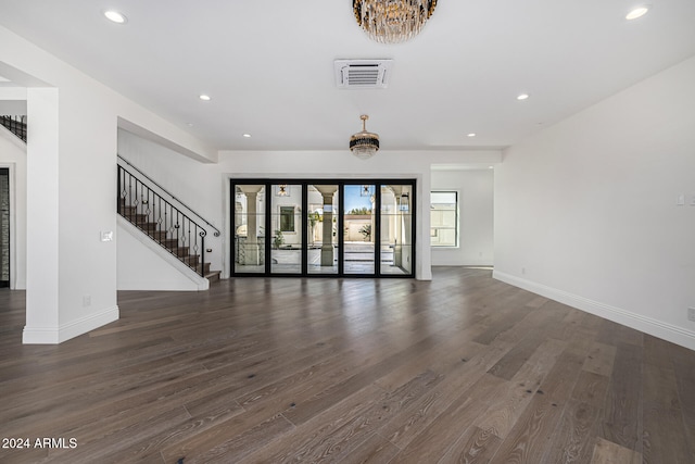 unfurnished living room with dark hardwood / wood-style floors