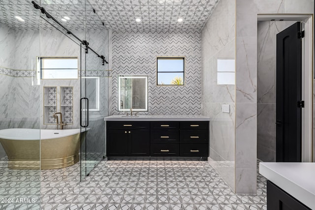 bathroom featuring tile walls, a healthy amount of sunlight, and tile patterned flooring