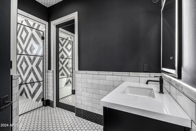 bathroom featuring tile patterned floors, vanity, and tile walls