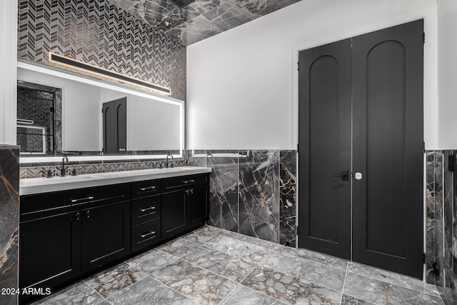 bathroom with vanity and tile walls