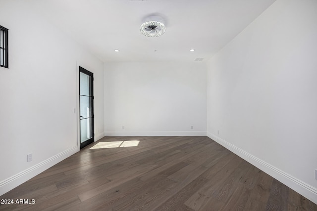 empty room with dark hardwood / wood-style flooring