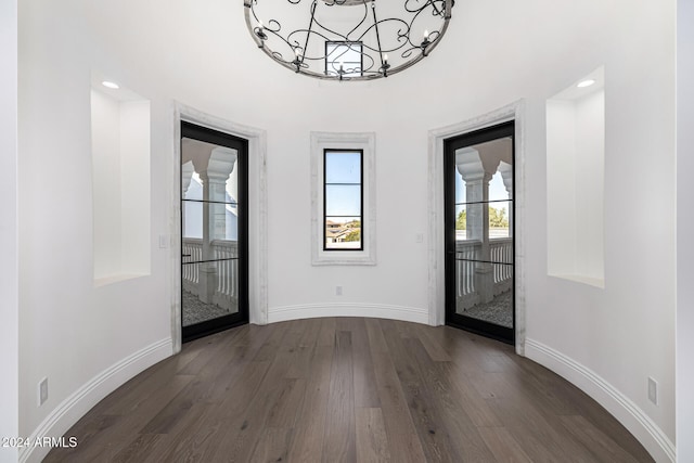 entryway featuring a wealth of natural light and dark hardwood / wood-style floors