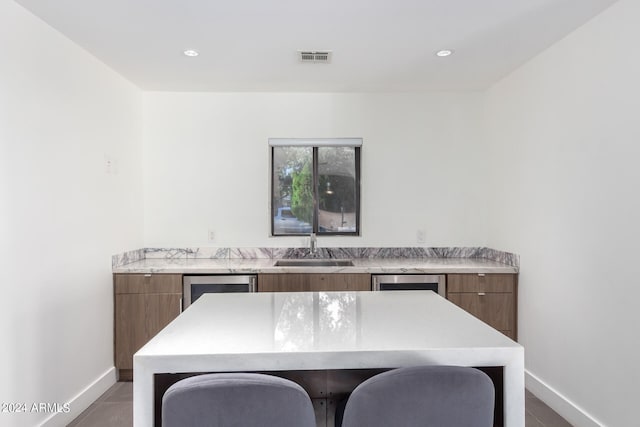 tiled home office with wine cooler and sink