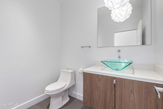 bathroom featuring tile patterned flooring, vanity, and toilet