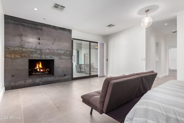 tiled bedroom featuring access to outside and a tiled fireplace