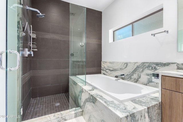 bathroom featuring tile walls, vanity, and independent shower and bath