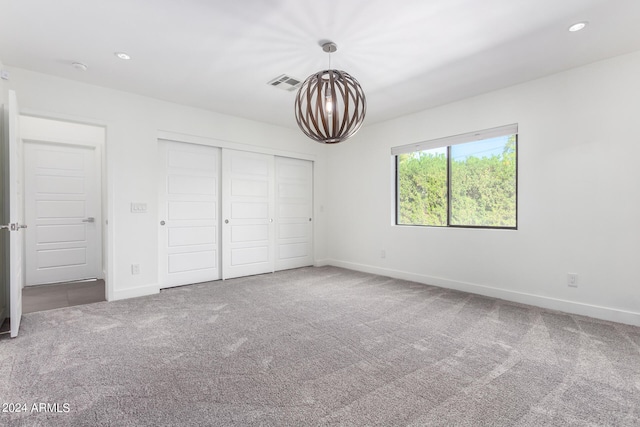 unfurnished bedroom featuring a closet and carpet flooring