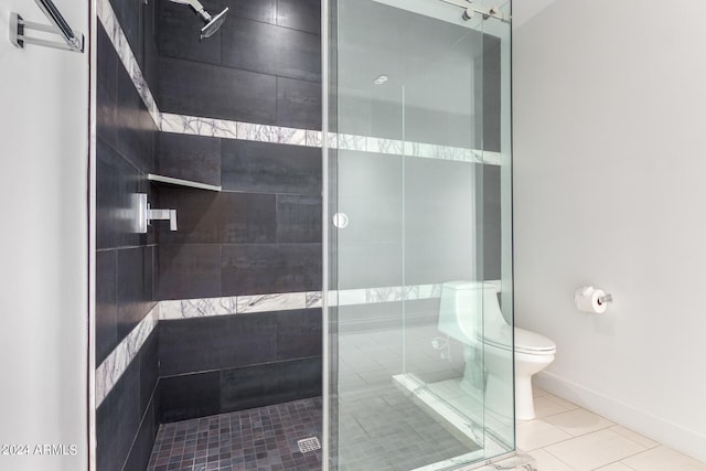 bathroom with tile patterned flooring, walk in shower, and toilet