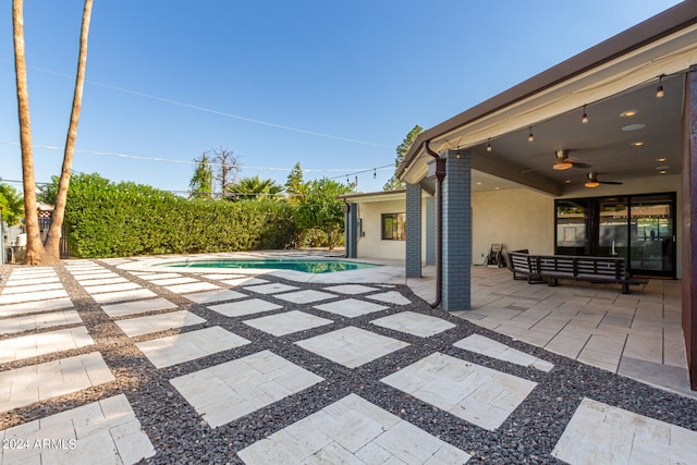 view of swimming pool featuring a patio area and ceiling fan